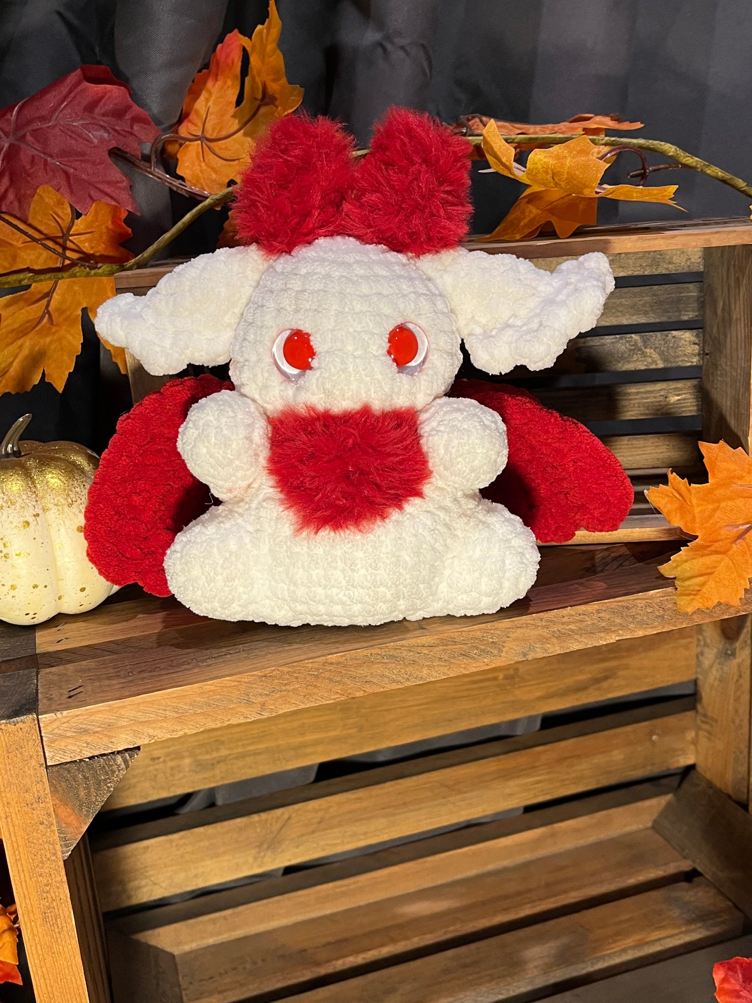 Handcrafted red crochet moth plushie